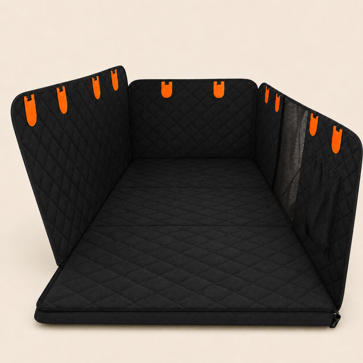 A black quilted pet Cover with diamond stitching, featuring bright orange hanging loops on the back panels and a mesh side panel, shown on a light beige background.