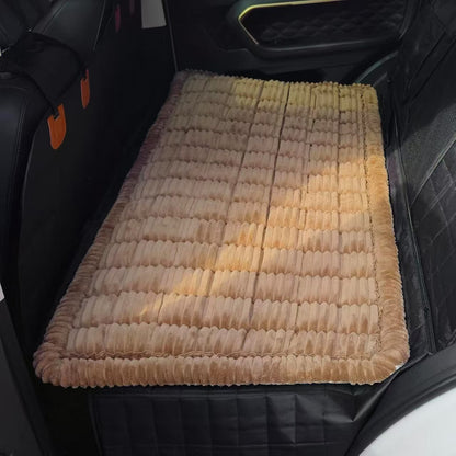 Brown plush dog bed mat covering a car back seat extender in the rear of an SUV