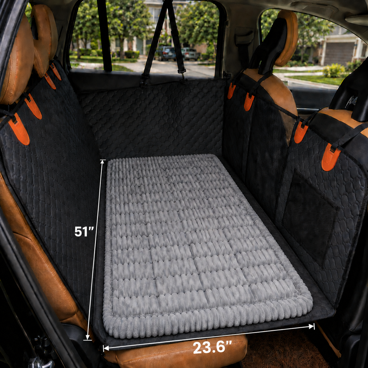 RoadGuard Comfort Pad installed on a back seat extender platform in a vehicle, with measurement lines showing 51 inches wide by 23.6 inches deep